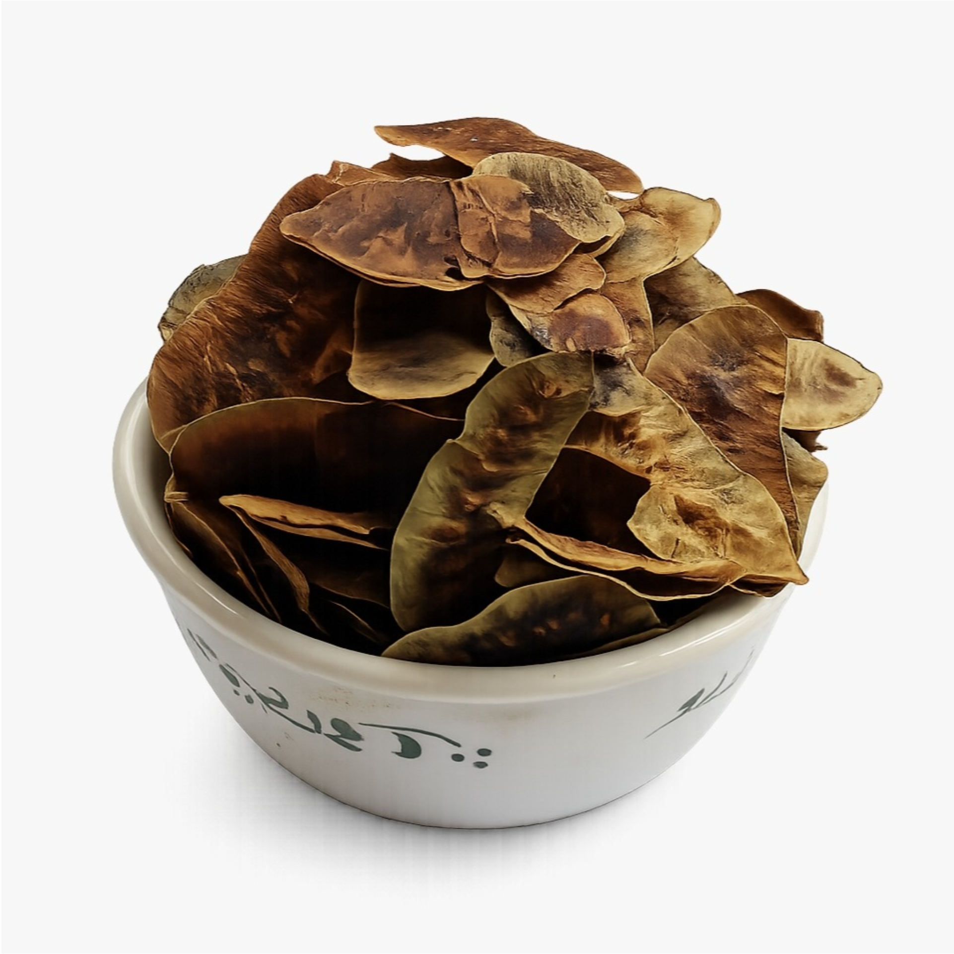 Dried senna pods in a white ceramic bowl